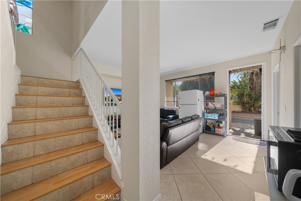 11159 St Tropez Drive Rancho Cucamonga, CA 91730 - Photo 5 of 40 a room with stairs and a large window