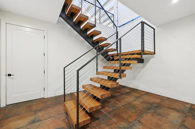 a view of a backyard with plants and chairs