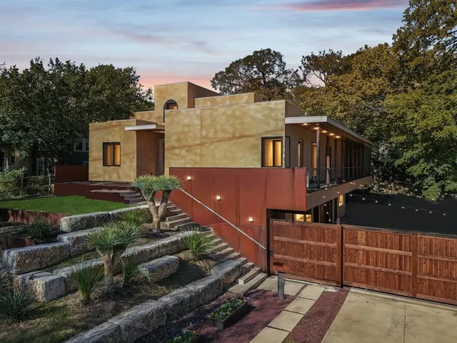 a kitchen with granite countertop wooden floors and white stainless steel appliances