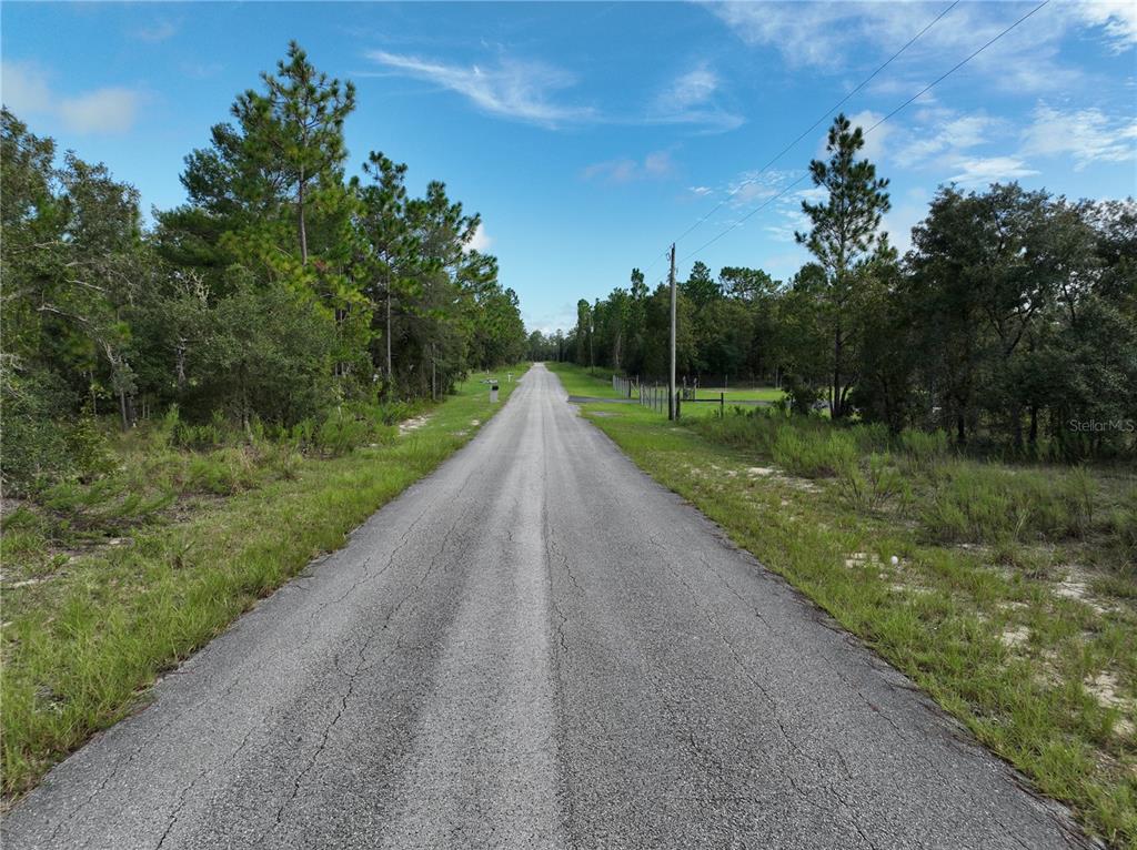 Tbd Southeast 129th Court Dunnellon, FL 34431 - Photo 22 of 25 a view of a street with a yard and a trees