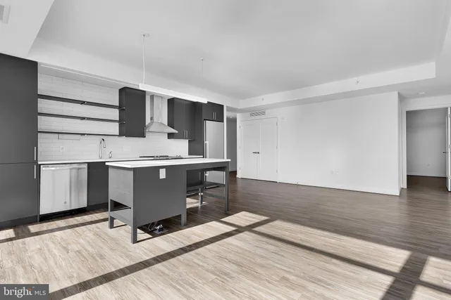 a kitchen with stainless steel appliances a stove a sink and a refrigerator