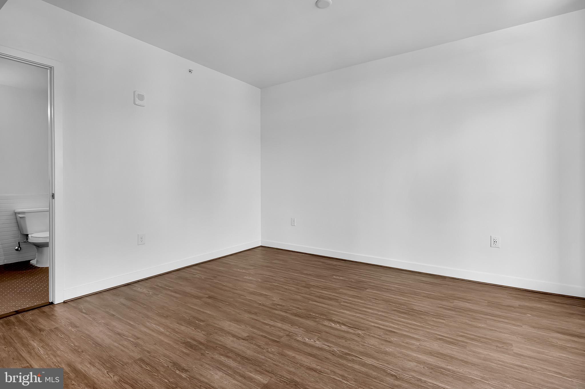 150 I Street Southeast, Unit 1 BR Washington, DC 20003 - Photo 6 of 26 a view of an empty room with wooden floor and a window