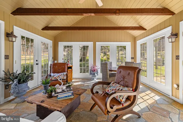 a living room with furniture and a floor to ceiling window