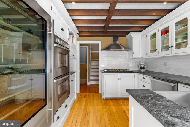 a living room with furniture a rug and a book shelf