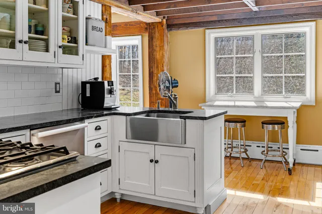 a bathroom with a sink mirror and a shower