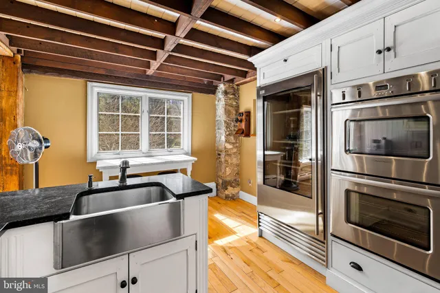 a bathroom with a sink mirror and a shower