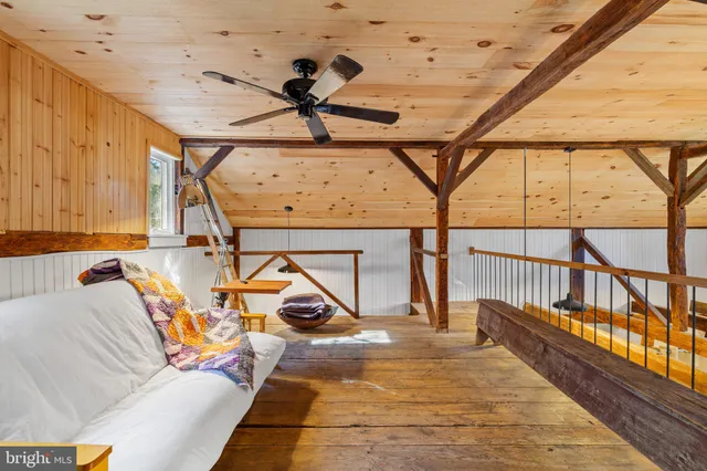 an aerial view of a house with yard and swimming pool