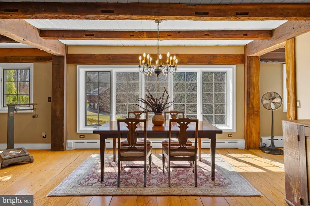a view of a dining room with furniture and a chandelier