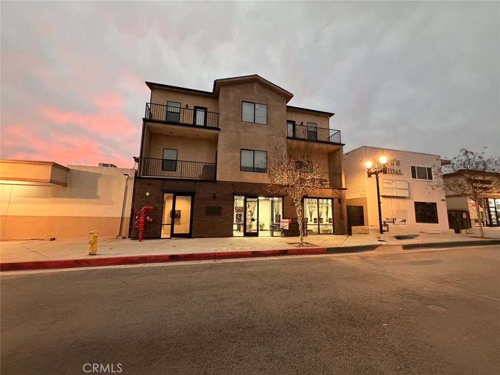 511 North Azusa Avenue, Unit 203 Azusa, CA 91702 - Photo 1 of 16 a front view of a building with many windows