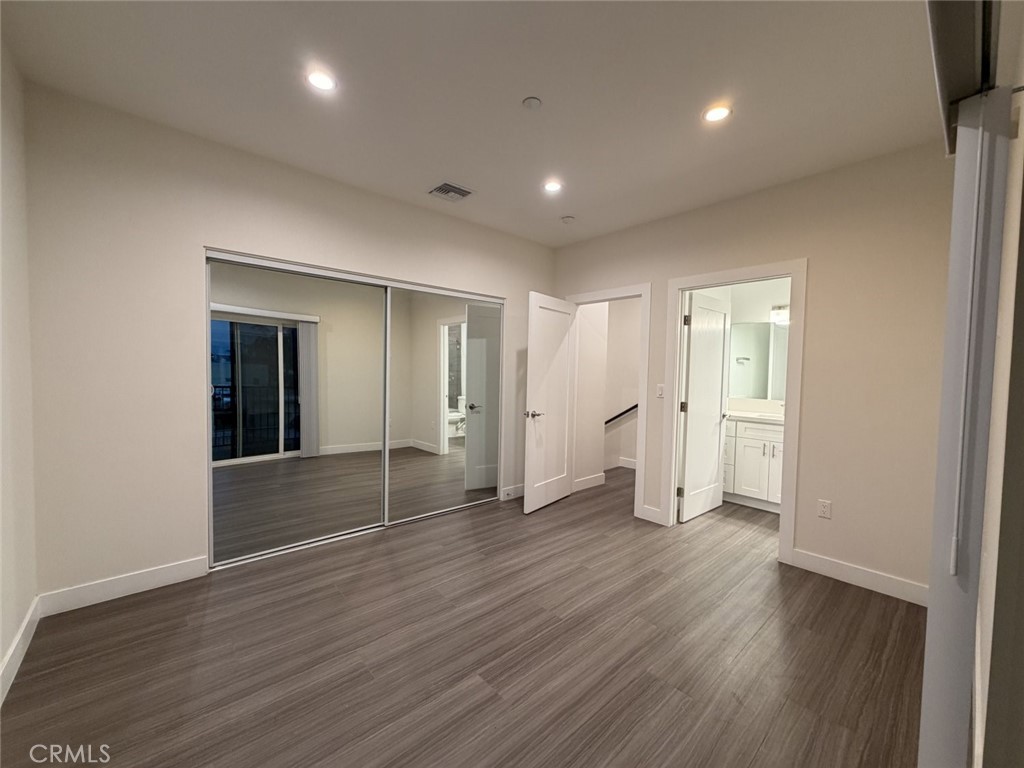 511 North Azusa Avenue, Unit 203 Azusa, CA 91702 - Photo 9 of 16 a view of wooden floor and windows in an empty room