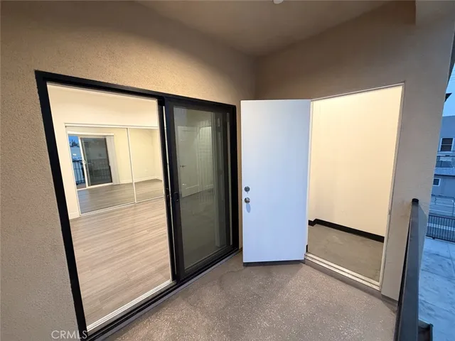 an empty room with mirror in front of it