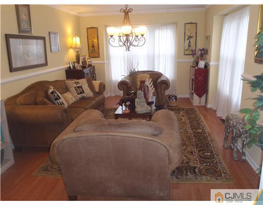 27 Cartwright Drive West Windsor, NJ 08550 - Photo 6 of 14 a living room with furniture a window and a chandelier