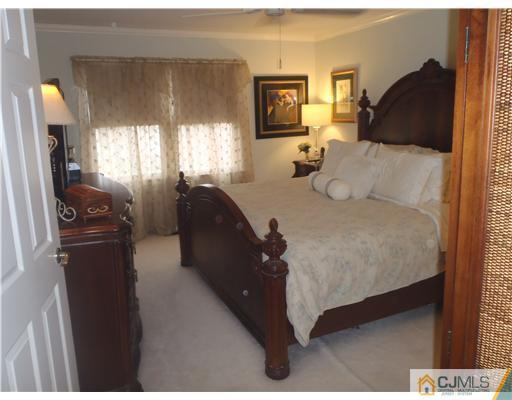 27 Cartwright Drive West Windsor, NJ 08550 - Photo 7 of 14 a bed sitting in a bedroom next to a window