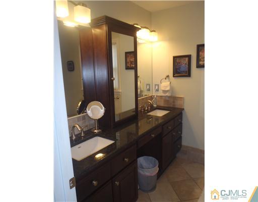 27 Cartwright Drive West Windsor, NJ 08550 - Photo 8 of 14 a bathroom with a toilet sink and mirror