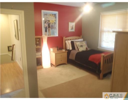 27 Cartwright Drive West Windsor, NJ 08550 - Photo 9 of 14 a bedroom with a bed and wooden floor