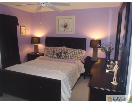 27 Cartwright Drive West Windsor, NJ 08550 - Photo 10 of 14 a bedroom with a bed and wooden floor