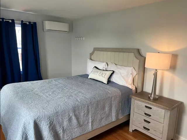 a bedroom with a large bed and a chandelier