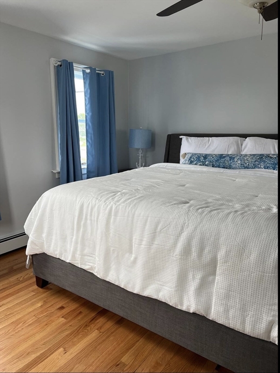 300 Ocean Street Marshfield, MA 02050 - Photo 24 of 30 a bedroom with a bed and wooden floor