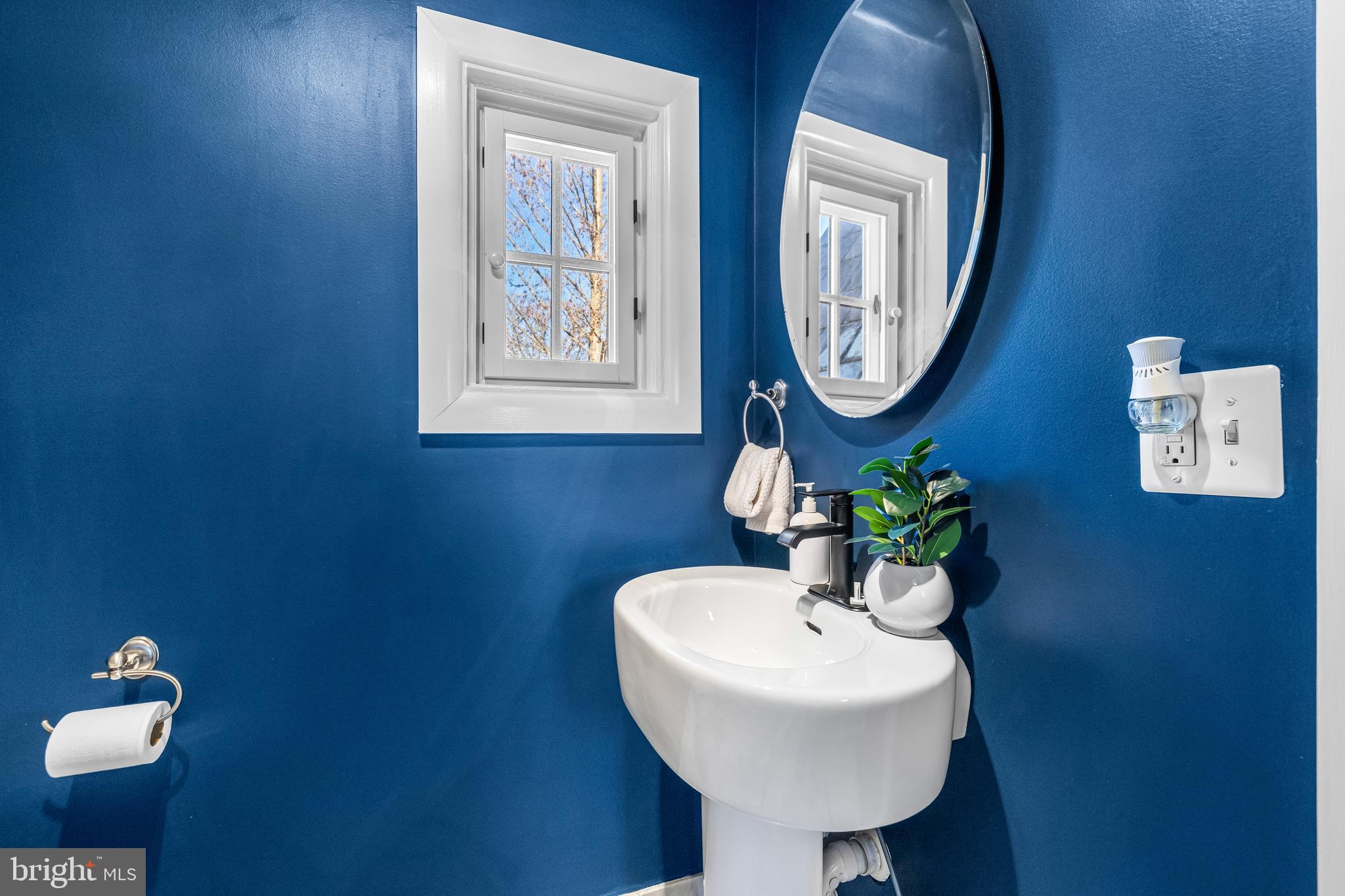 307 East Highfield Road Baltimore, MD 21218 - Photo 37 of 59 a bathroom with a toilet a sink and mirror