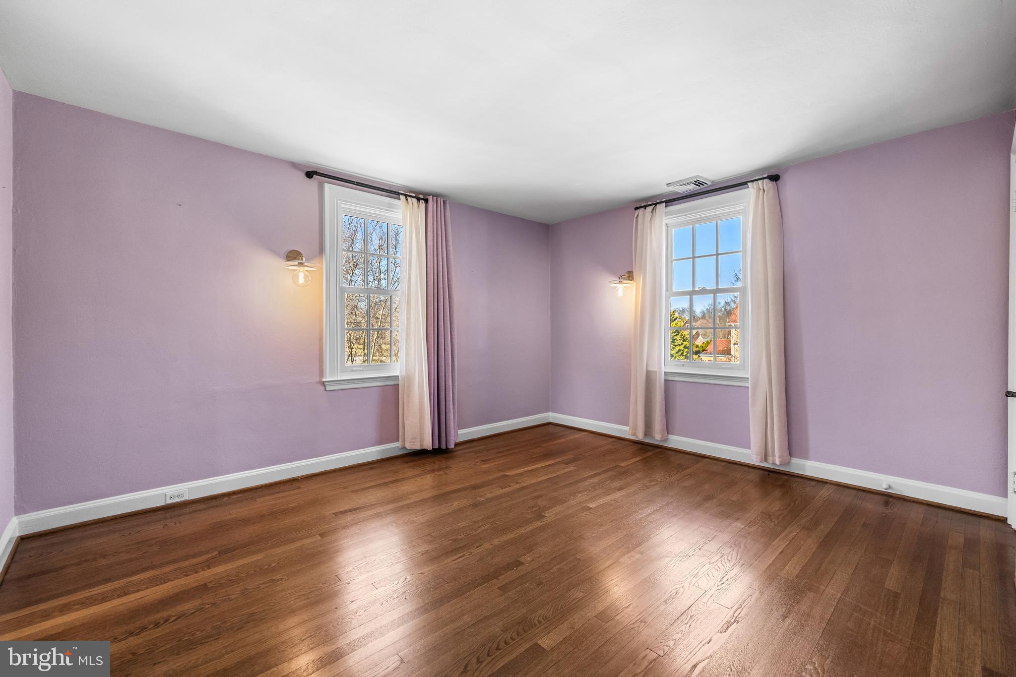 307 East Highfield Road Baltimore, MD 21218 - Photo 43 of 59 an empty room with wooden floor and windows