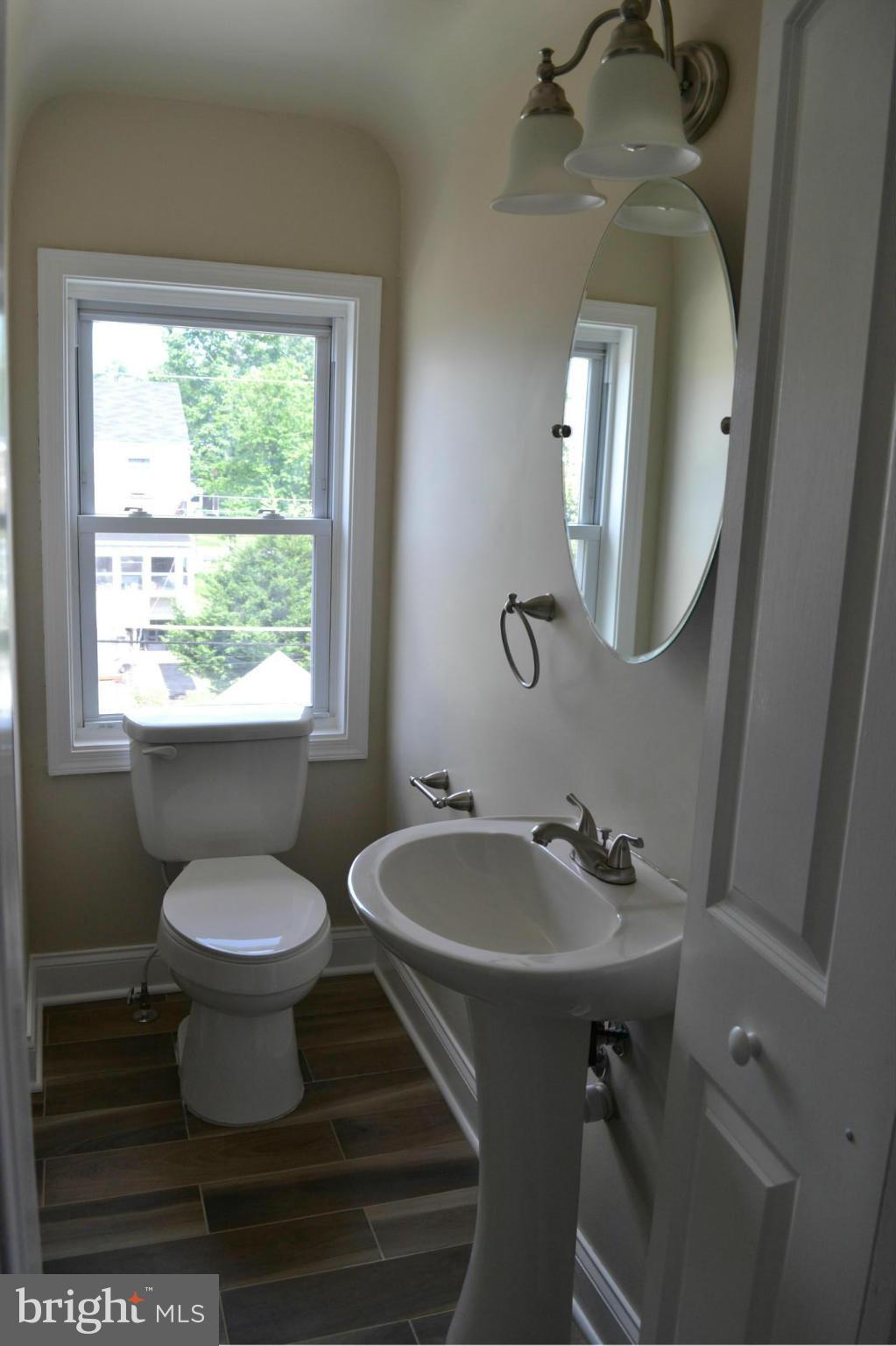 23 Eastship Road Baltimore, MD 21222 - Photo 15 of 30 a bathroom with a toilet sink and mirror
