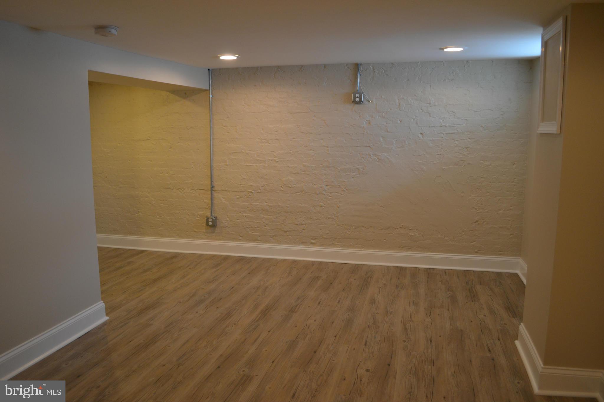 23 Eastship Road Baltimore, MD 21222 - Photo 17 of 30 a view of an empty room with wooden floor and a window