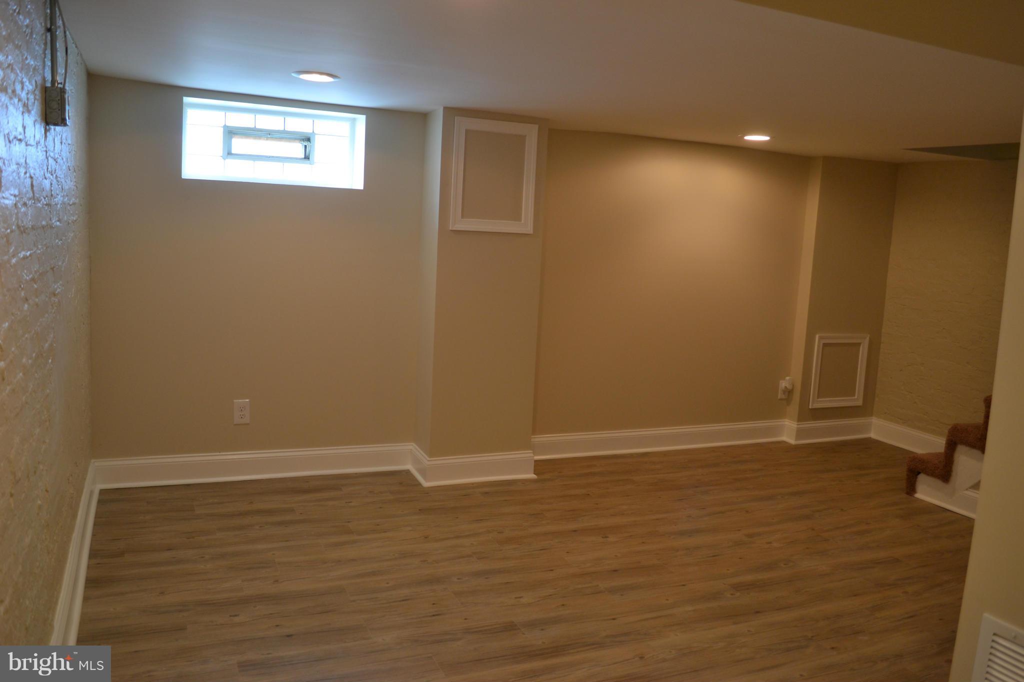 23 Eastship Road Baltimore, MD 21222 - Photo 18 of 30 a view of an empty room with wooden floor and a window