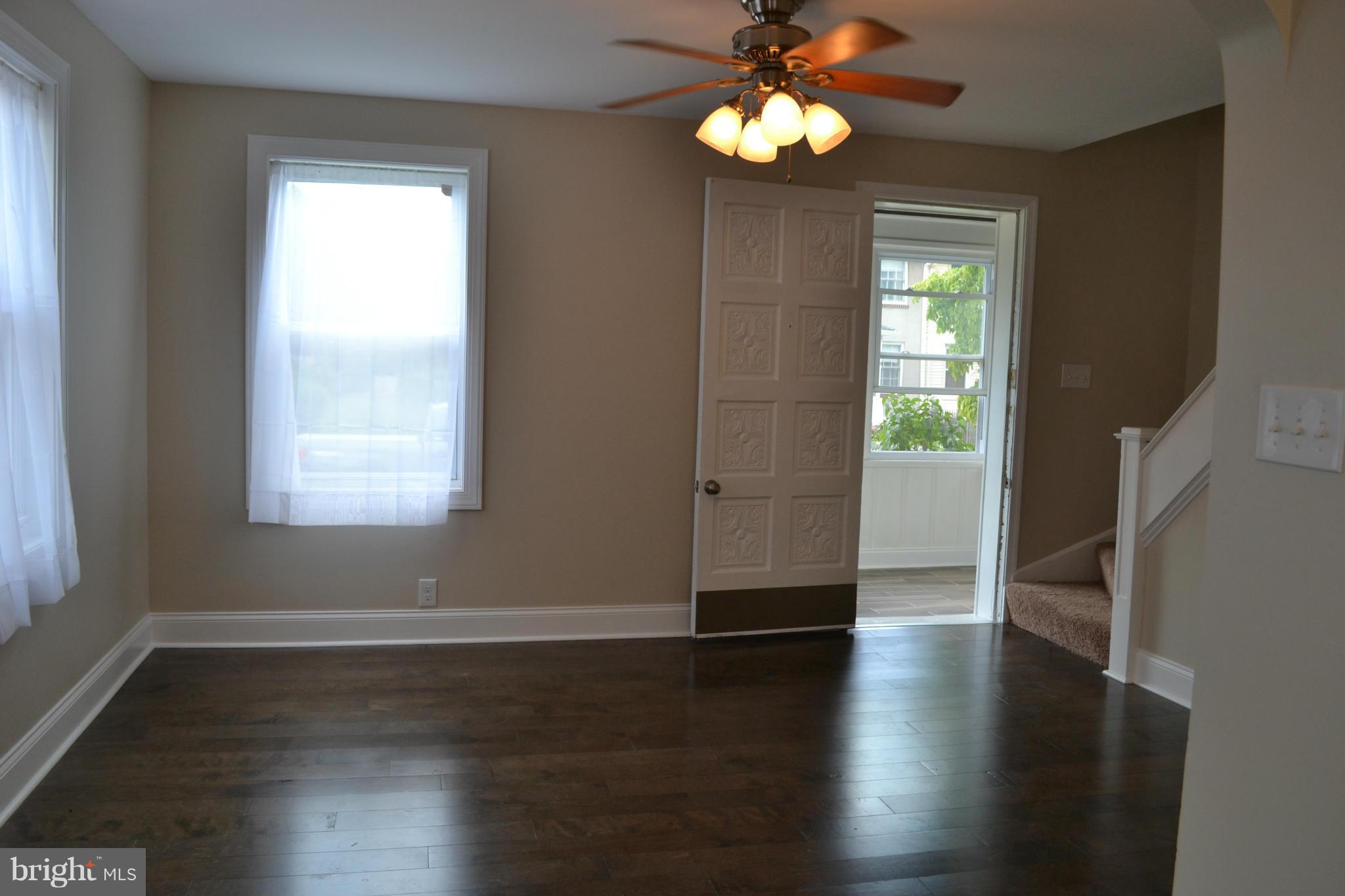 23 Eastship Road Baltimore, MD 21222 - Photo 5 of 30 an empty room with wooden floor and windows