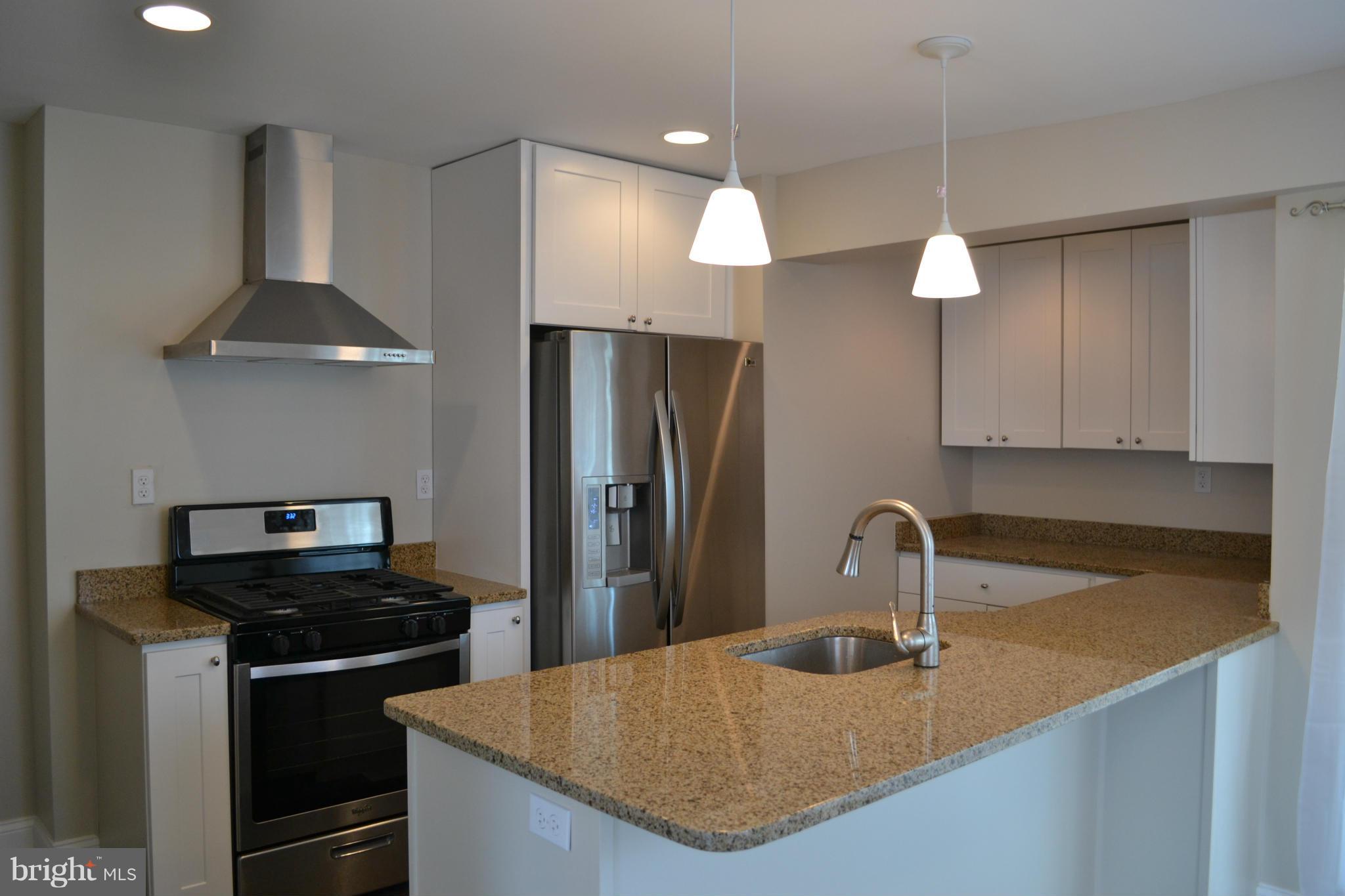 23 Eastship Road Baltimore, MD 21222 - Photo 7 of 30 a kitchen with stainless steel appliances granite countertop a sink a stove and a refrigerator