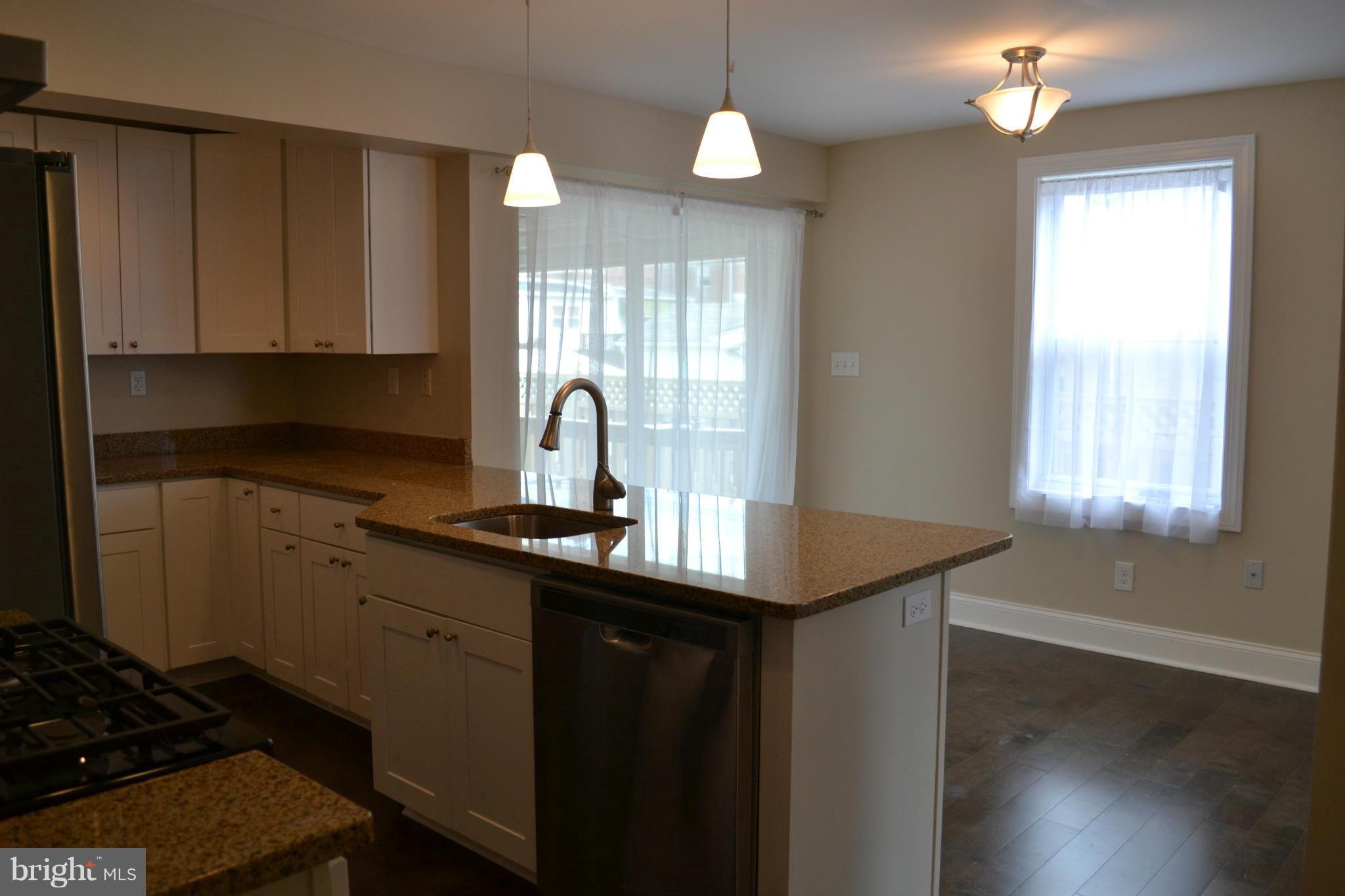 23 Eastship Road Baltimore, MD 21222 - Photo 8 of 30 a kitchen with a sink cabinets and wooden floor