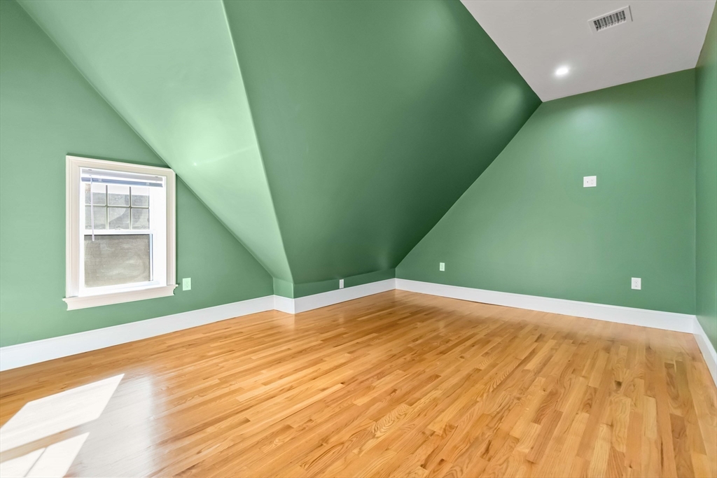 51 Mansfield Street, Unit 49 Everett, MA 02149 - Photo 26 of 31 a view of a room with a wooden floor and windows