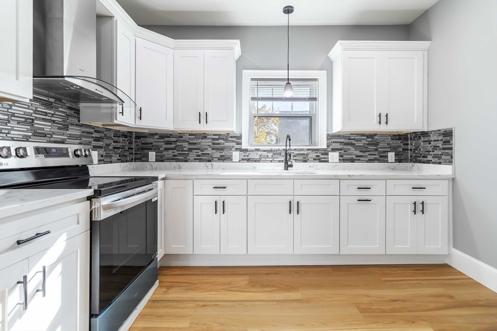 51 Mansfield Street, Unit 49 Everett, MA 02149 - Photo 3 of 31 a kitchen with white cabinets and sink