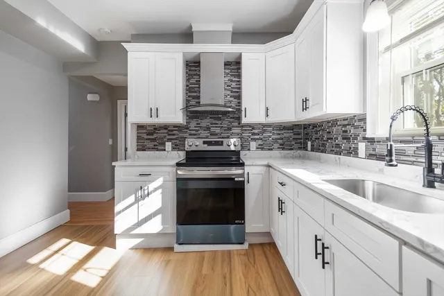 a kitchen with stainless steel appliances granite countertop a stove and a sink