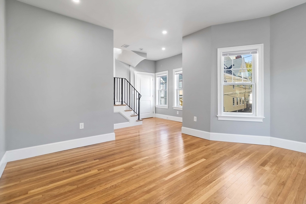 51 Mansfield Street, Unit 49 Everett, MA 02149 - Photo 8 of 31 a view of empty room with wooden floor and fan