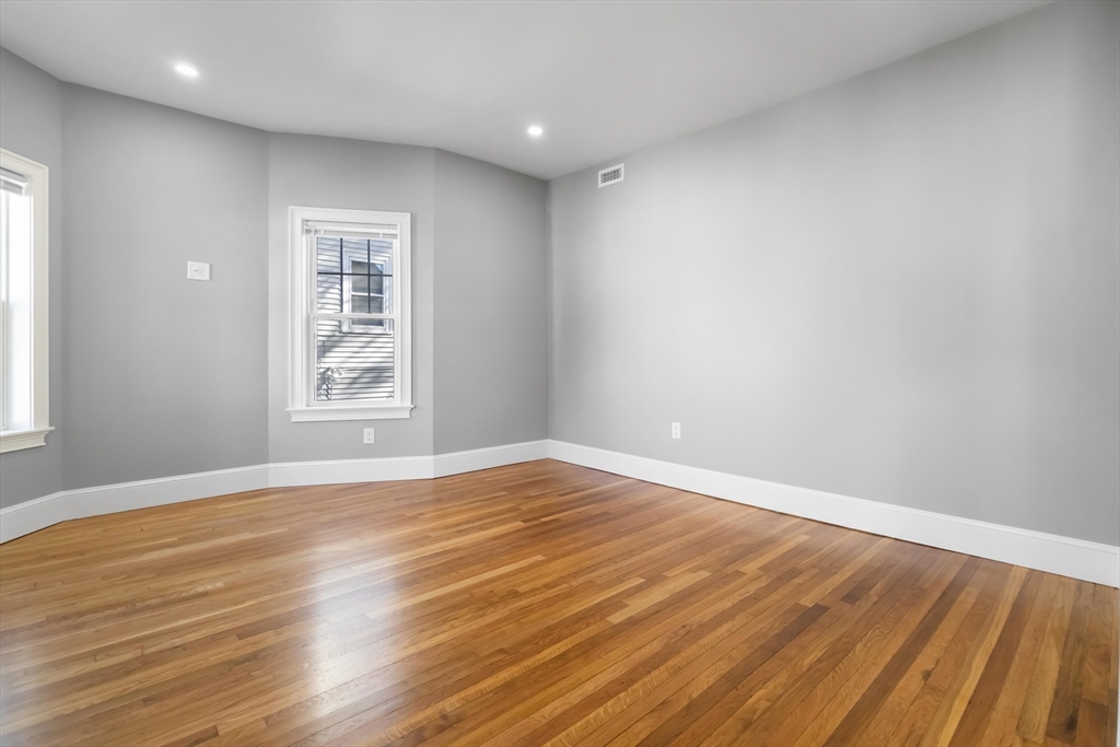 51 Mansfield Street, Unit 49 Everett, MA 02149 - Photo 9 of 31 a view of an empty room with wooden floor and a window