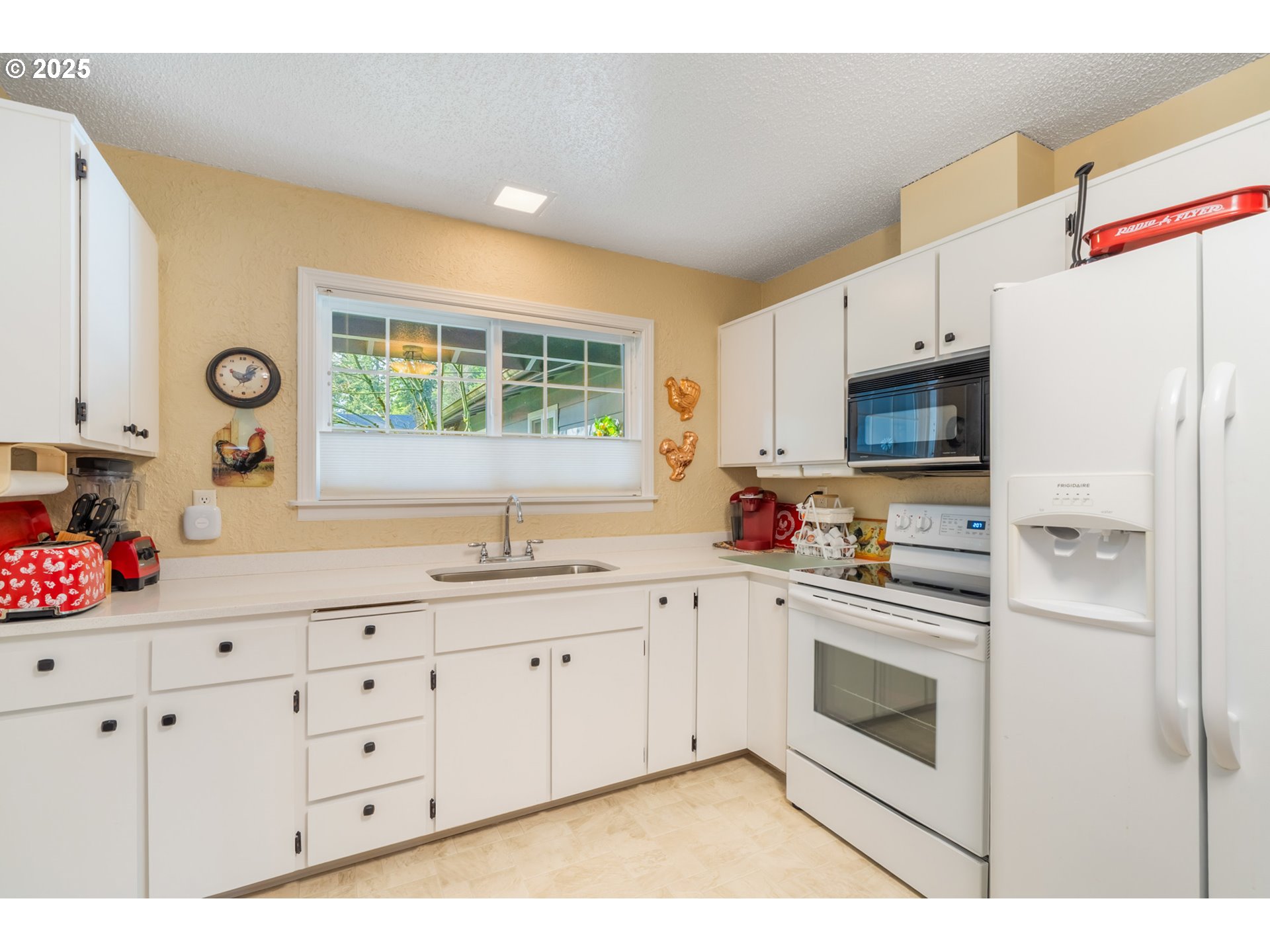16808 Southwest Inverurie Road Lake Oswego, OR 97035 - Photo 15 of 38 a kitchen with granite countertop white cabinets and white appliances