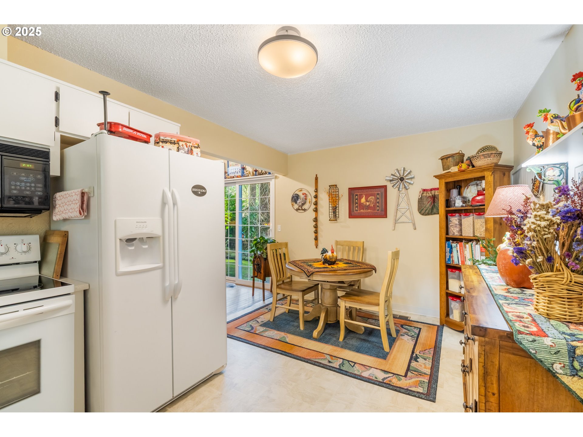 16808 Southwest Inverurie Road Lake Oswego, OR 97035 - Photo 16 of 38 a white kitchen with a refrigerator and furniture