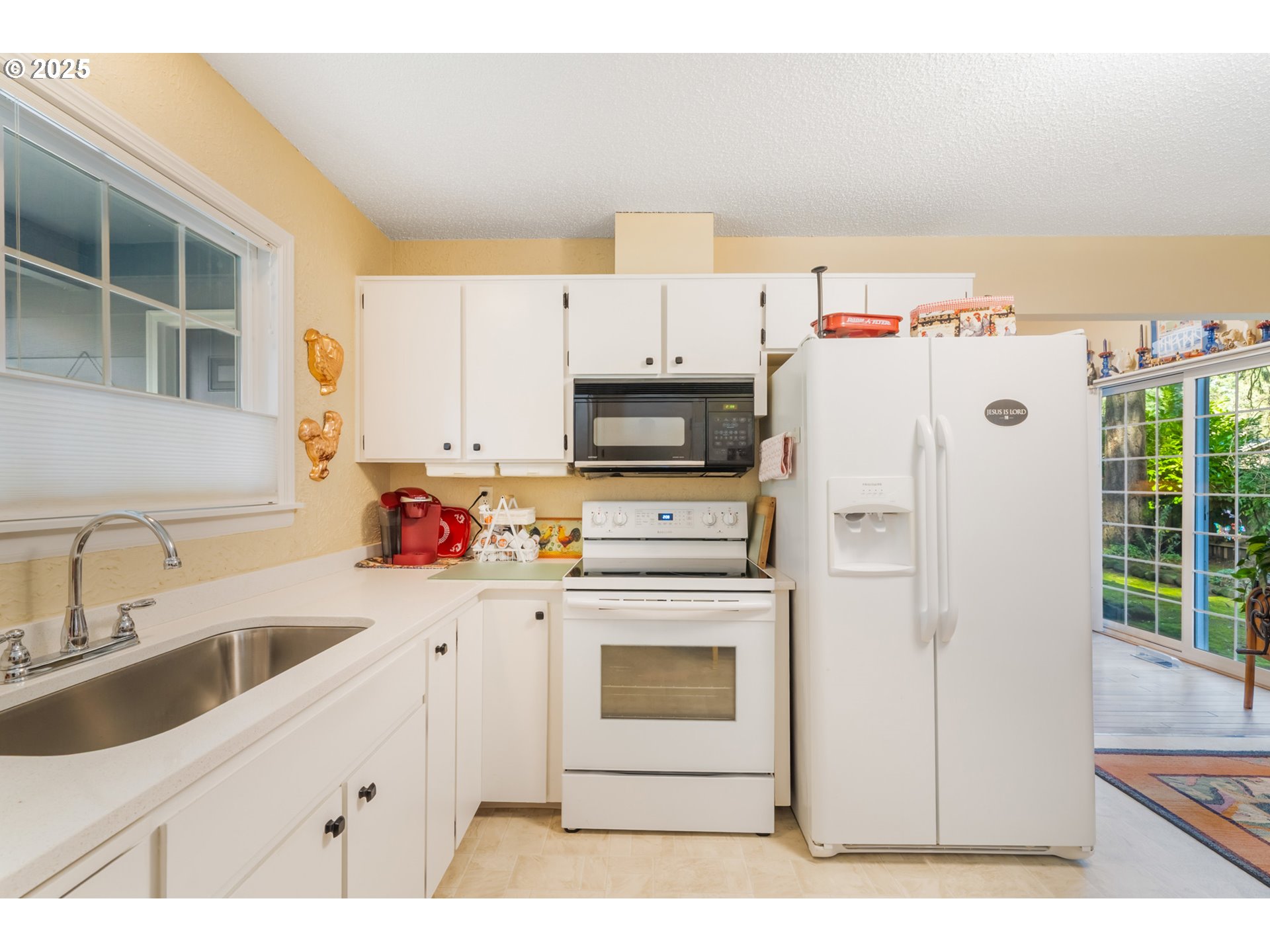 16808 Southwest Inverurie Road Lake Oswego, OR 97035 - Photo 17 of 38 a kitchen with stainless steel appliances a refrigerator sink and cabinets