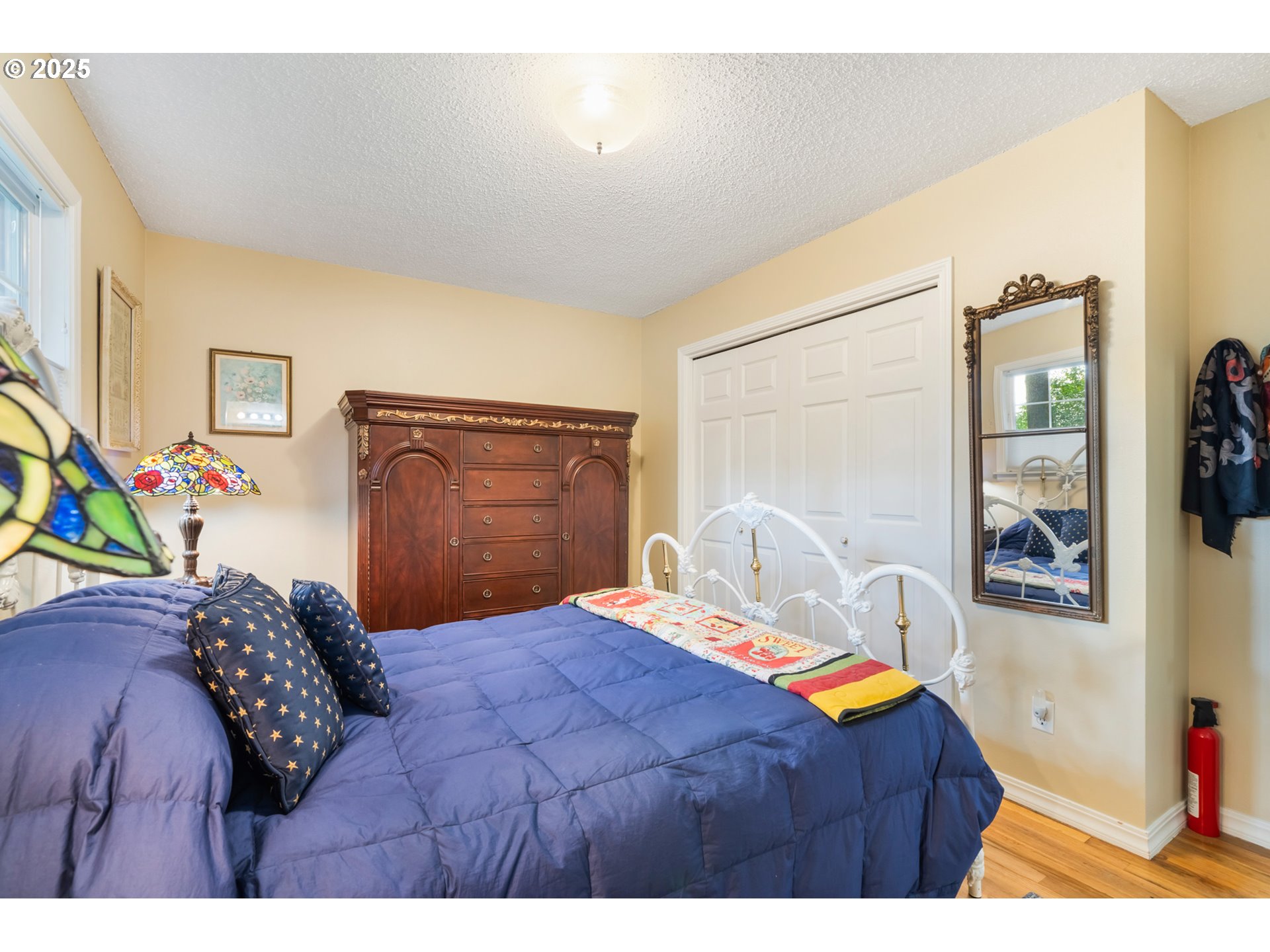 16808 Southwest Inverurie Road Lake Oswego, OR 97035 - Photo 19 of 38 a bedroom with a bed and a painting on the wall