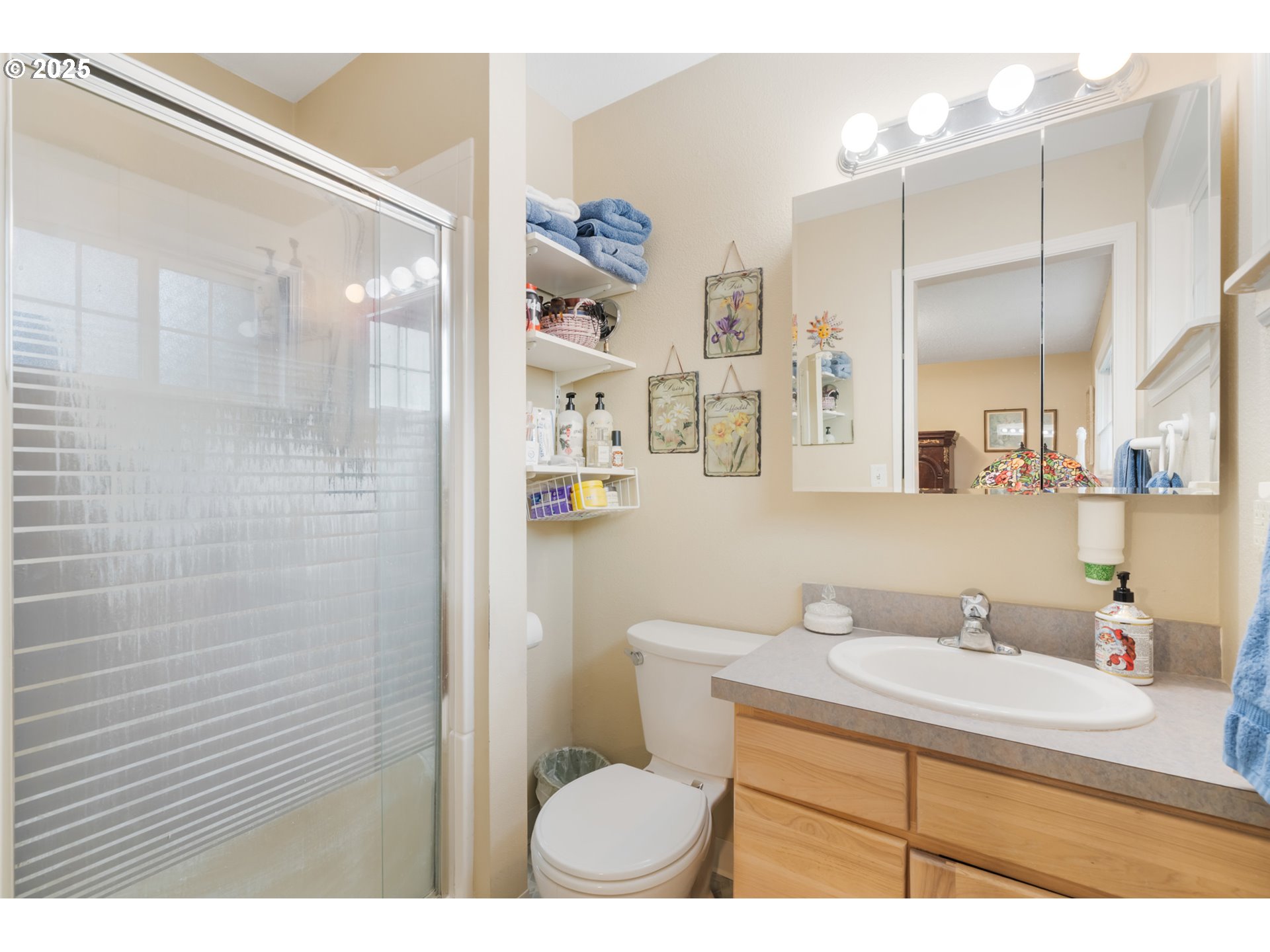 16808 Southwest Inverurie Road Lake Oswego, OR 97035 - Photo 21 of 38 a bathroom with a sink a toilet a shower and a mirror