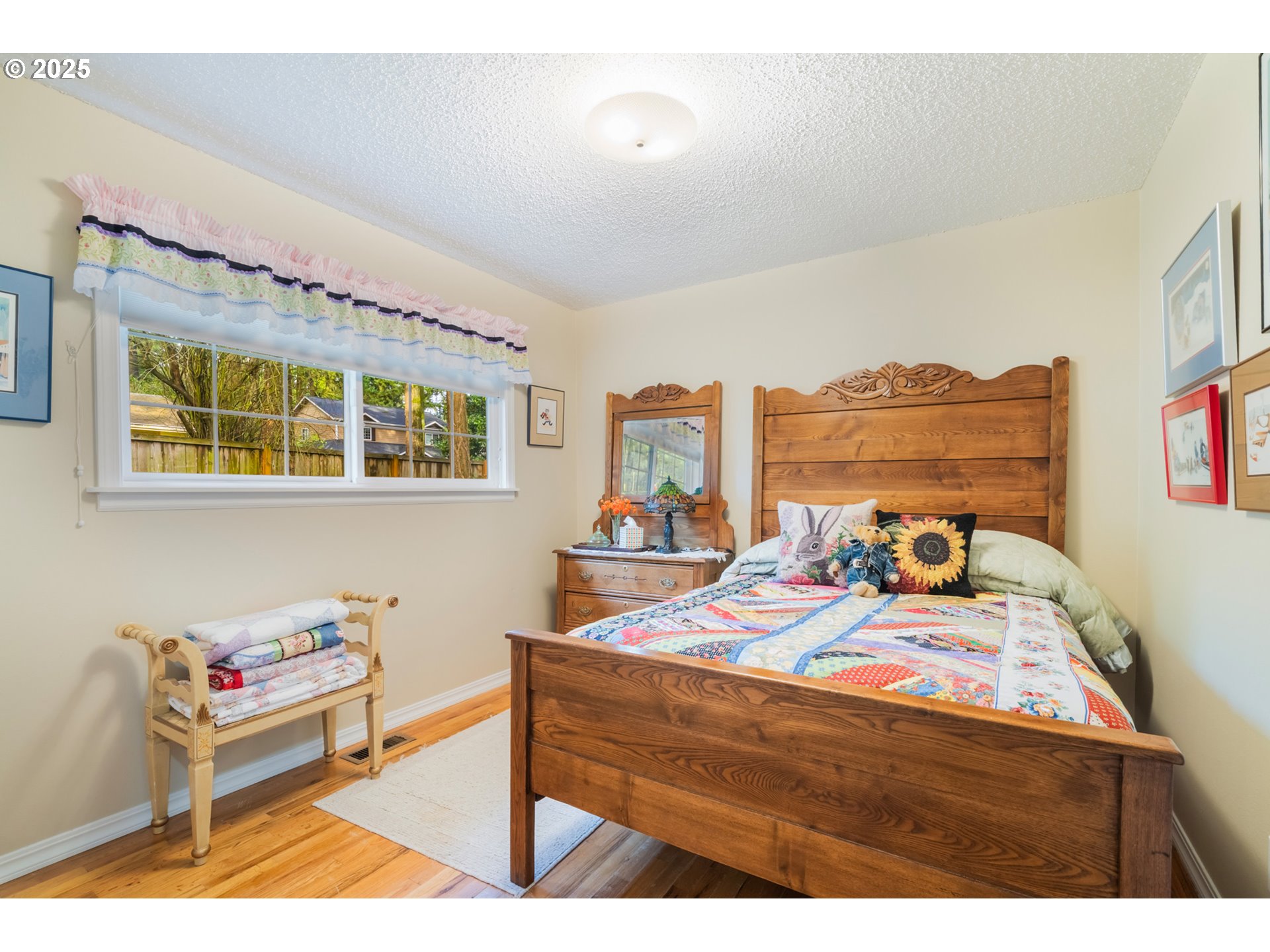 16808 Southwest Inverurie Road Lake Oswego, OR 97035 - Photo 23 of 38 a bedroom with a bed and wooden floor