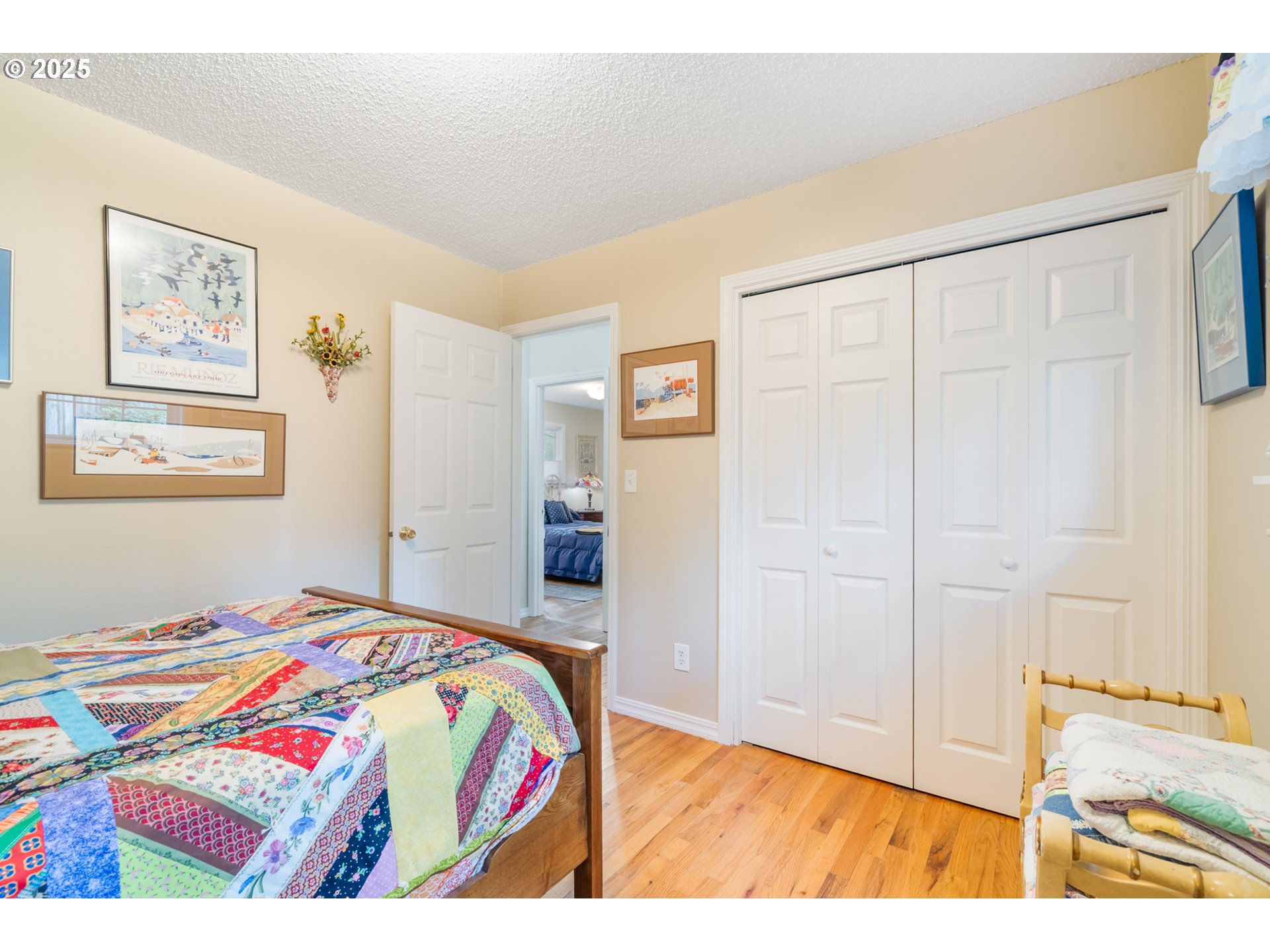 16808 Southwest Inverurie Road Lake Oswego, OR 97035 - Photo 25 of 38 a bedroom with a bed and a painting on the wall
