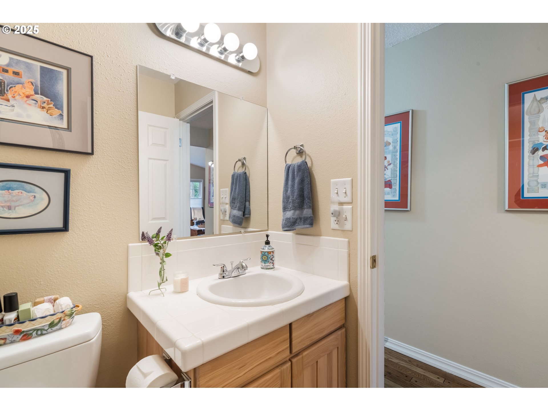 16808 Southwest Inverurie Road Lake Oswego, OR 97035 - Photo 27 of 38 a bathroom with a sink vanity and a mirror