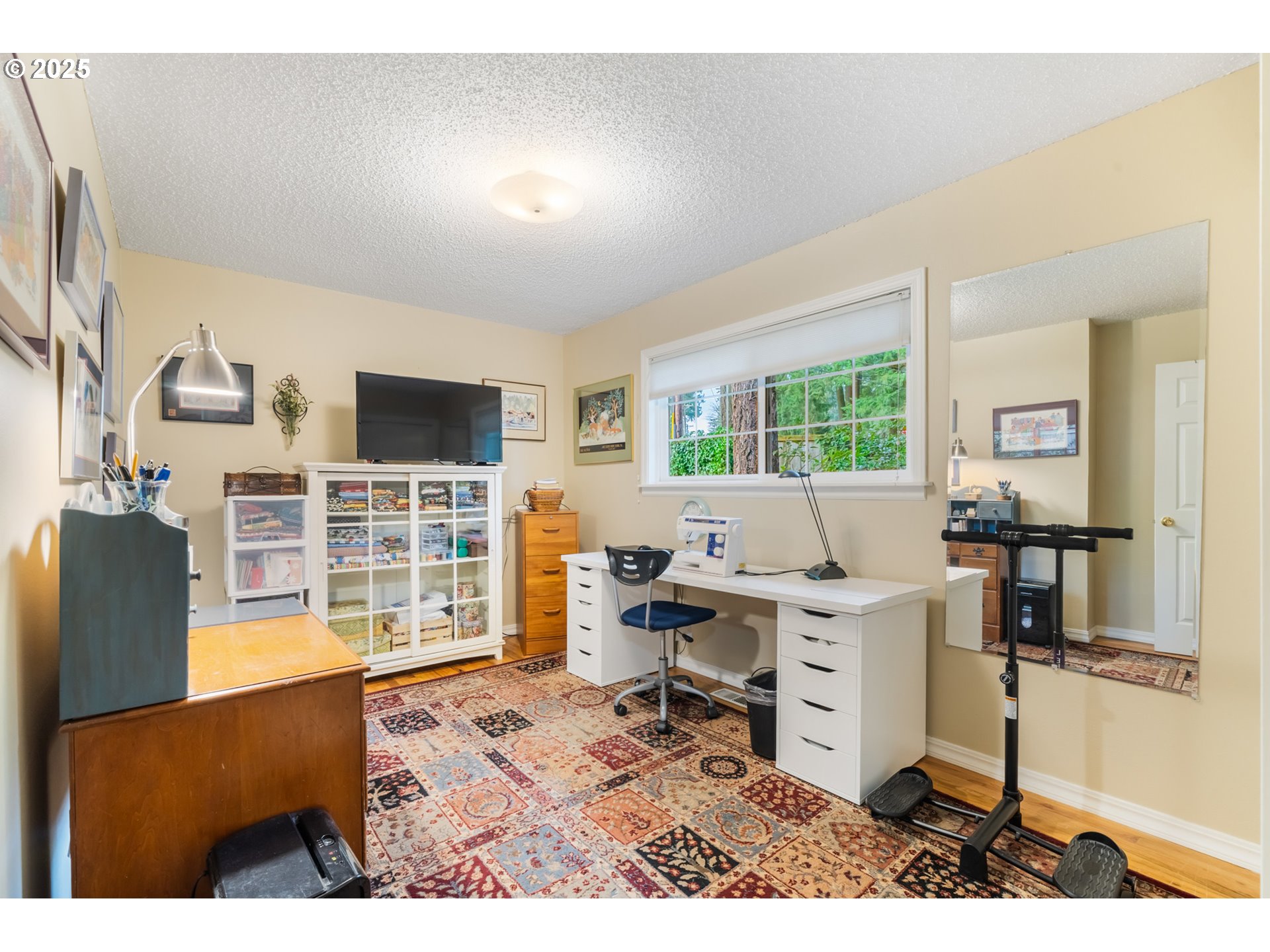 16808 Southwest Inverurie Road Lake Oswego, OR 97035 - Photo 28 of 38 a work room with furniture a rug and a flat screen tv