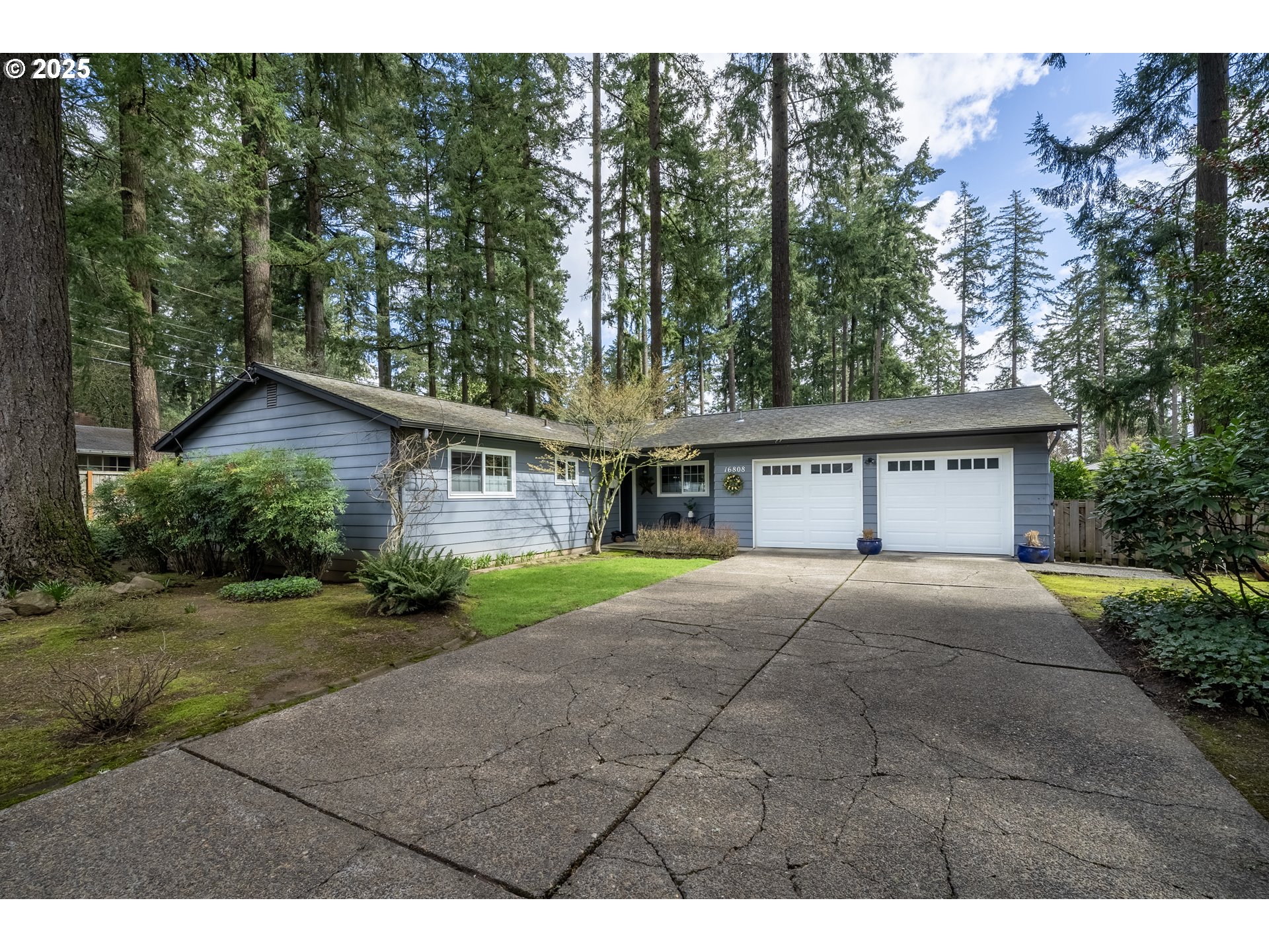 16808 Southwest Inverurie Road Lake Oswego, OR 97035 - Photo 38 of 38 a view of house with outdoor space and tall trees