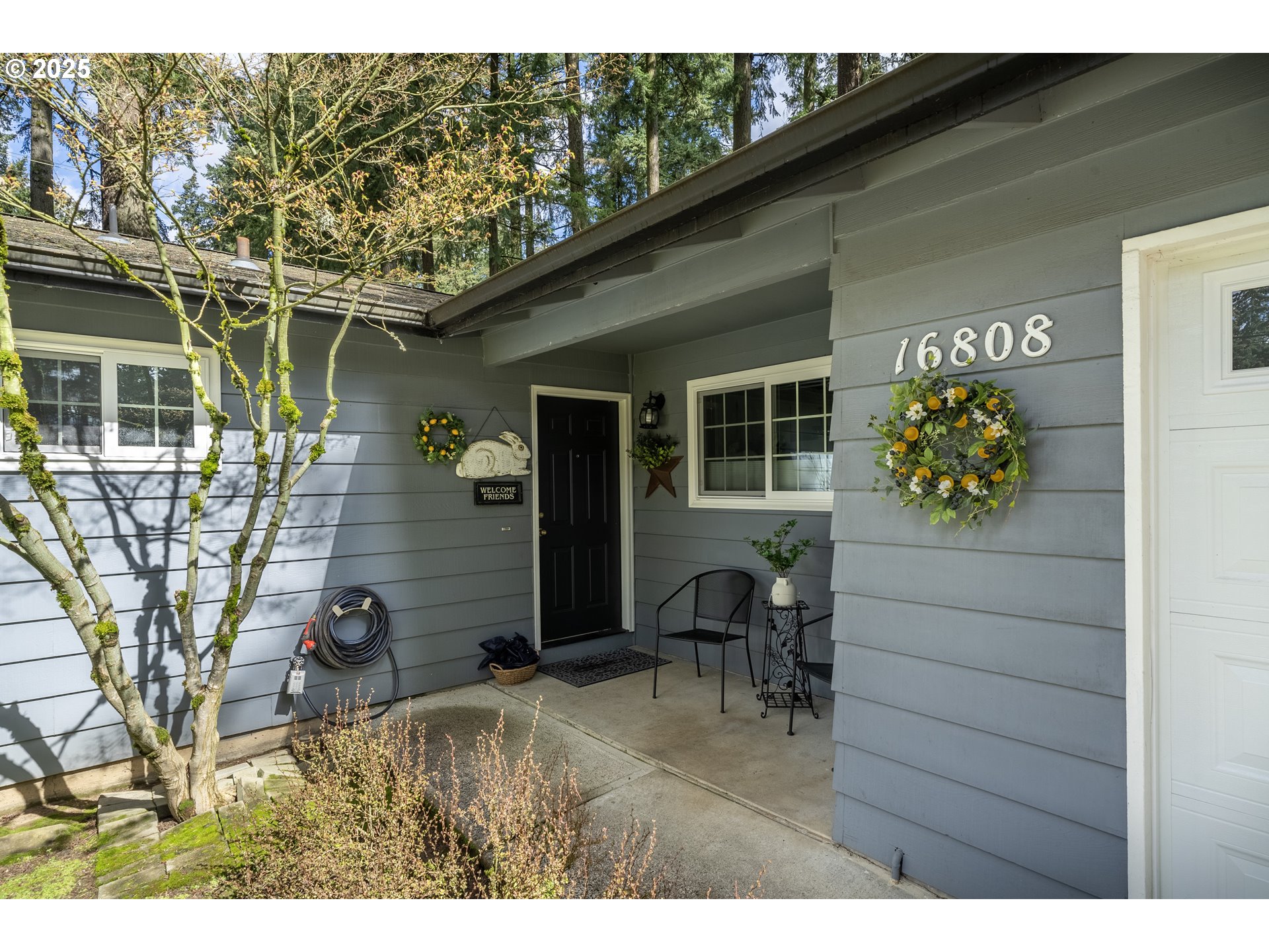 16808 Southwest Inverurie Road Lake Oswego, OR 97035 - Photo 5 of 38 a backyard of a house with table and chairs
