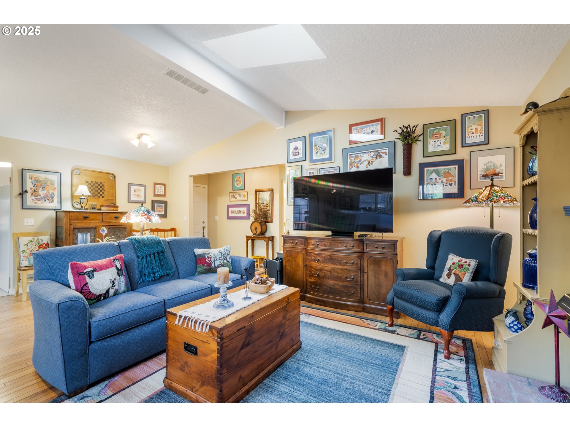 16808 Southwest Inverurie Road Lake Oswego, OR 97035 - Photo 9 of 38 a living room with furniture a flat screen tv and a fireplace