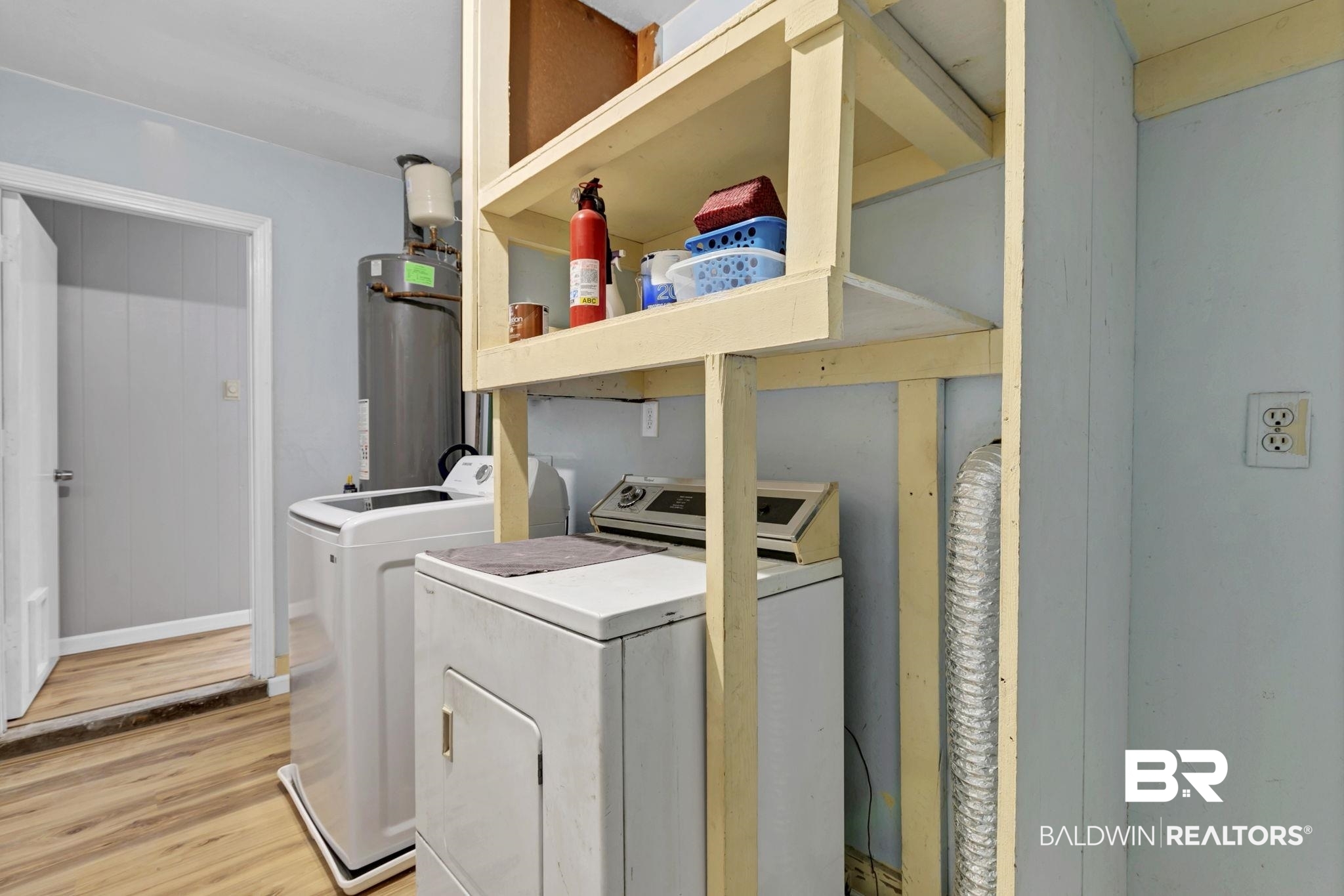 5817 Woodgate Road Mobile, AL 36609 - Photo 62 of 85 Clothes washing area with gas water heater, light wood-style floors, separate washer and dryer, laundry area, and baseboards