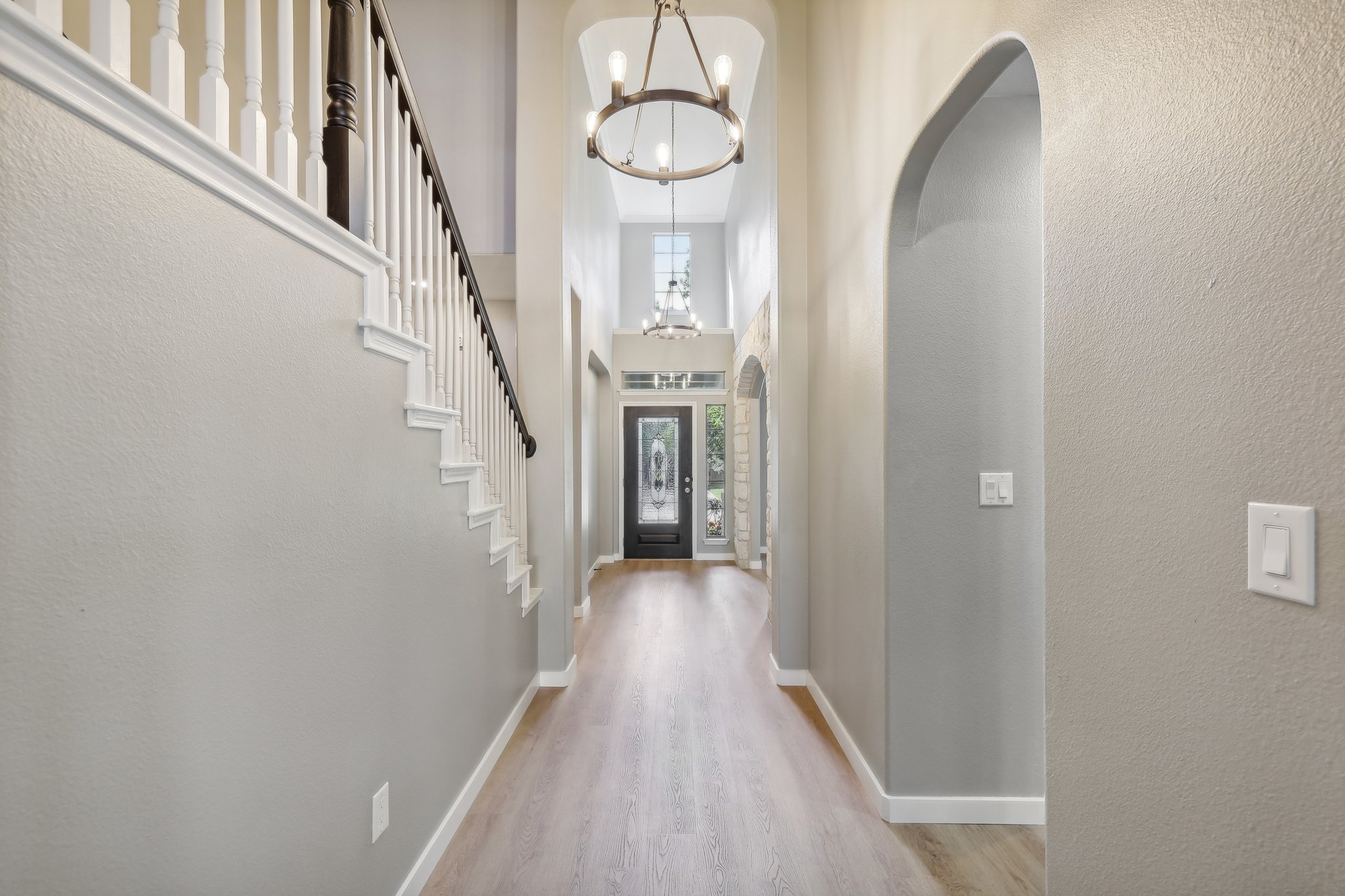 7324 Moon Rock Road Austin, TX 78739 - Photo 3 of 30 a view of a hallway with wooden floor and staircase