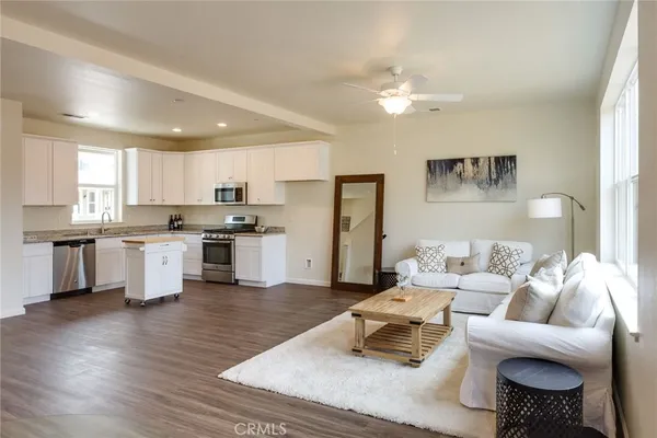 a living room with furniture and kitchen view